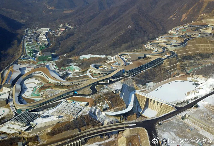国家雪车雪橇中心赛道航拍全景，蜿蜒滑道依山势铺展