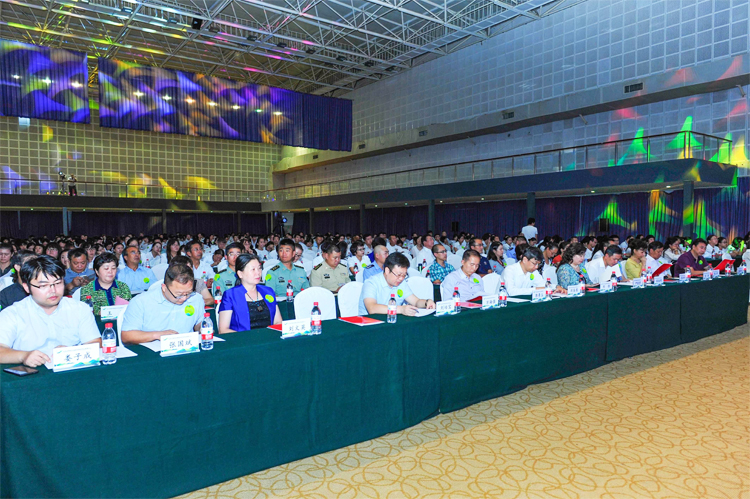 温泉苏家坨第二届教育大会会场全景，与会者列席聆听，舞台大屏环绕