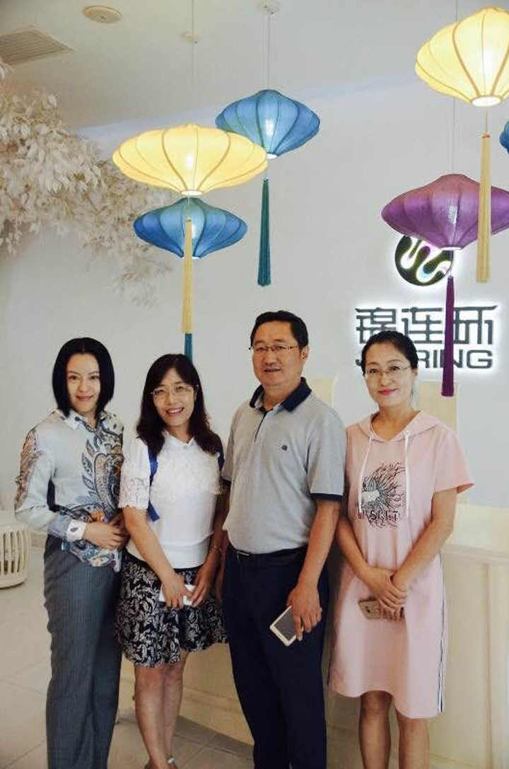 锦连环团队成员与兰州华侨实验学校教师在校园室内合影，开展品牌调研