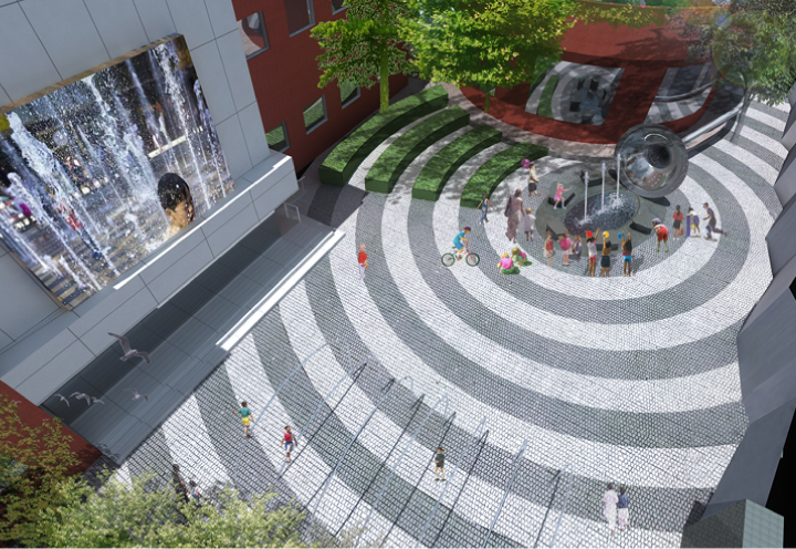 田村中心小学圆形铺装广场俯拍实景，同心圆地面构成校园环境建设亮点