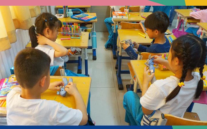 史家小学学生围坐课桌前认真绘制椅子创意设计稿，锦连环设计课堂实践现场
